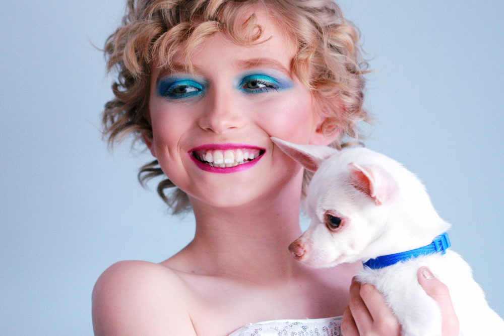 woman in white tube-top dress carrying white chihuahua