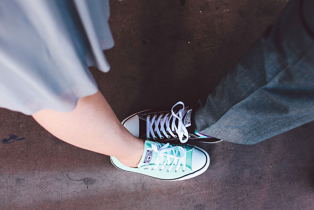 two people comparing converse shoes