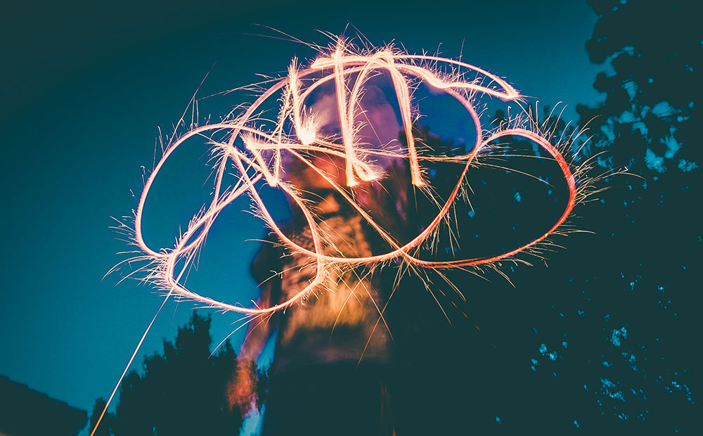 Light drawing with sparkler at night