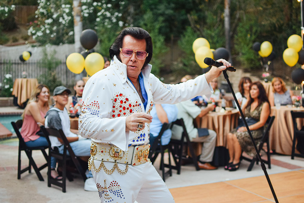 Elvis impersonator with crowd in the background